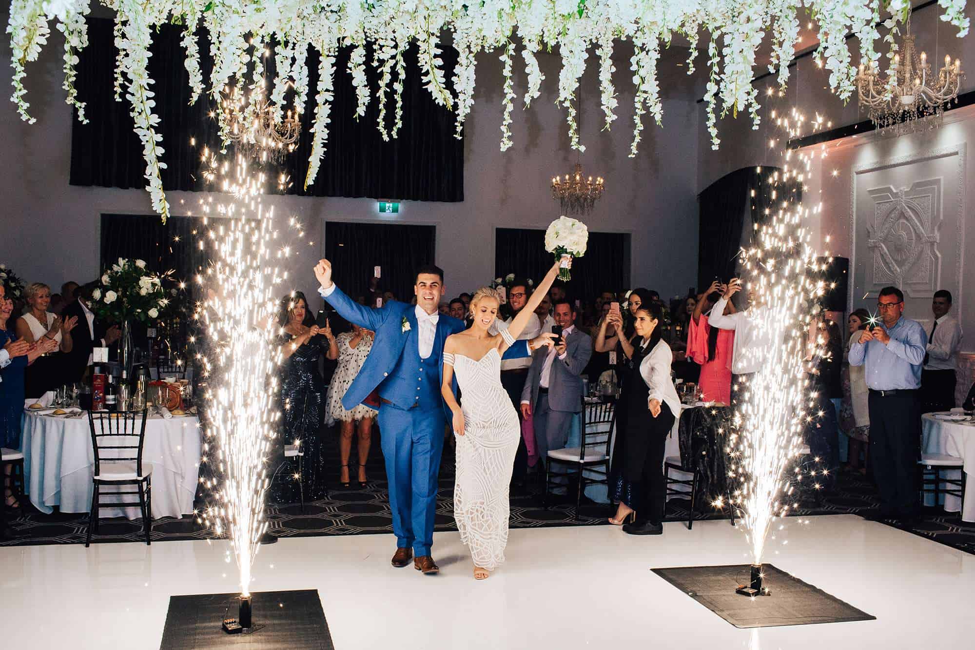 engaged couple walking onto dance floor